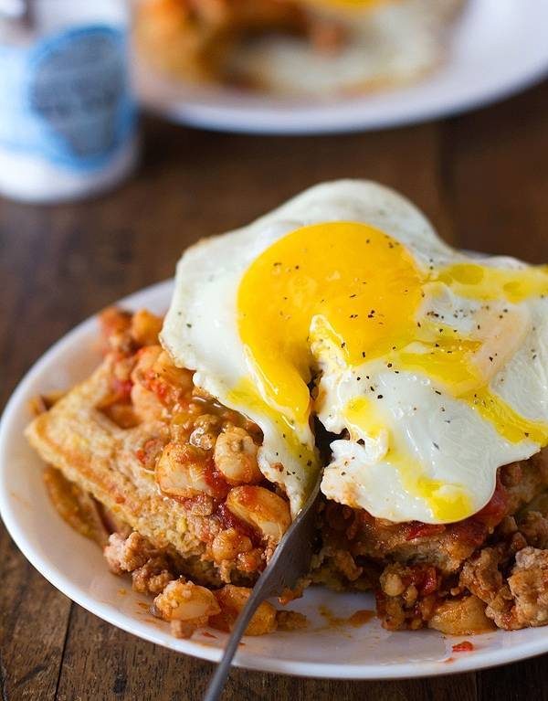 Chili and cornbread waffle stacks with an egg.
