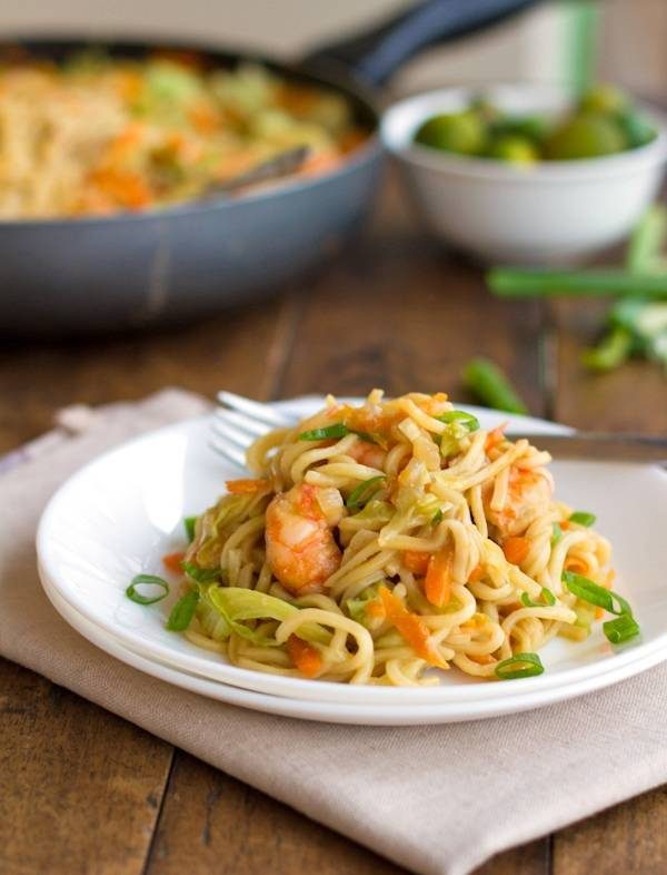 Stir fried noodles with shrimp and vegetables on a plate.