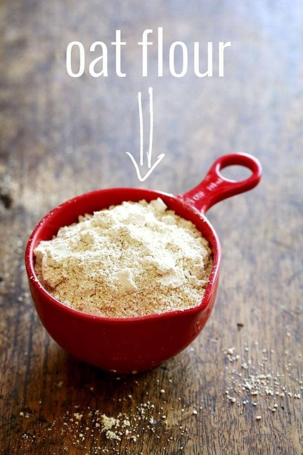 Oat flour in a red measuring cup.