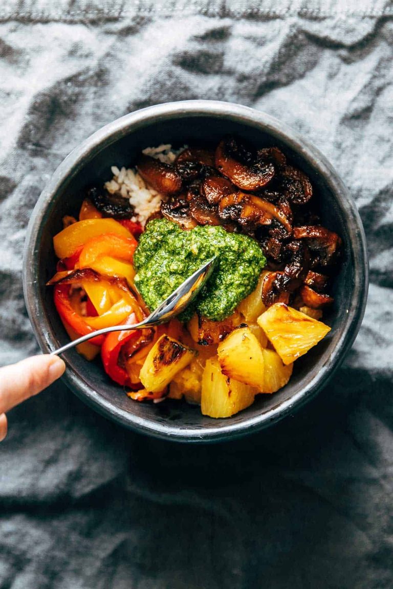 Mushroom, peppers, and pineapple in a bowl with kale pesto.